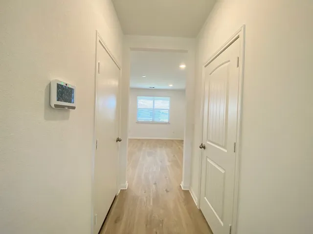 a view of a hallway with wooden floor