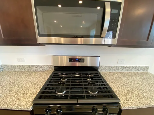 a stove top oven sitting inside of a kitchen