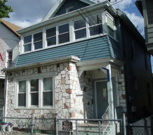 a view of a brick house with large windows