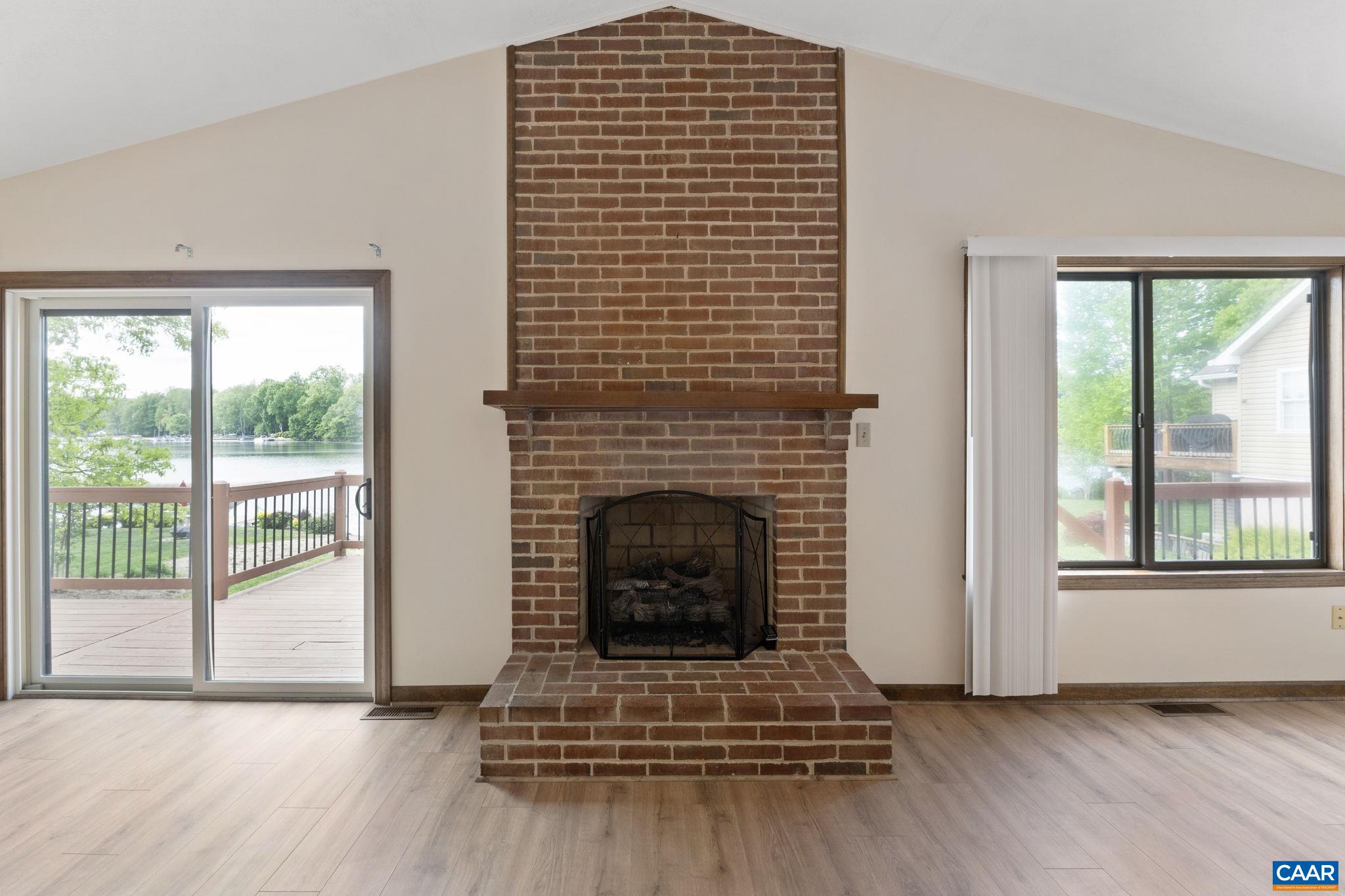 43 Tanglewood Road Palmyra, VA 22963 - Photo 18 of 64 a living room with a fireplace and windows
