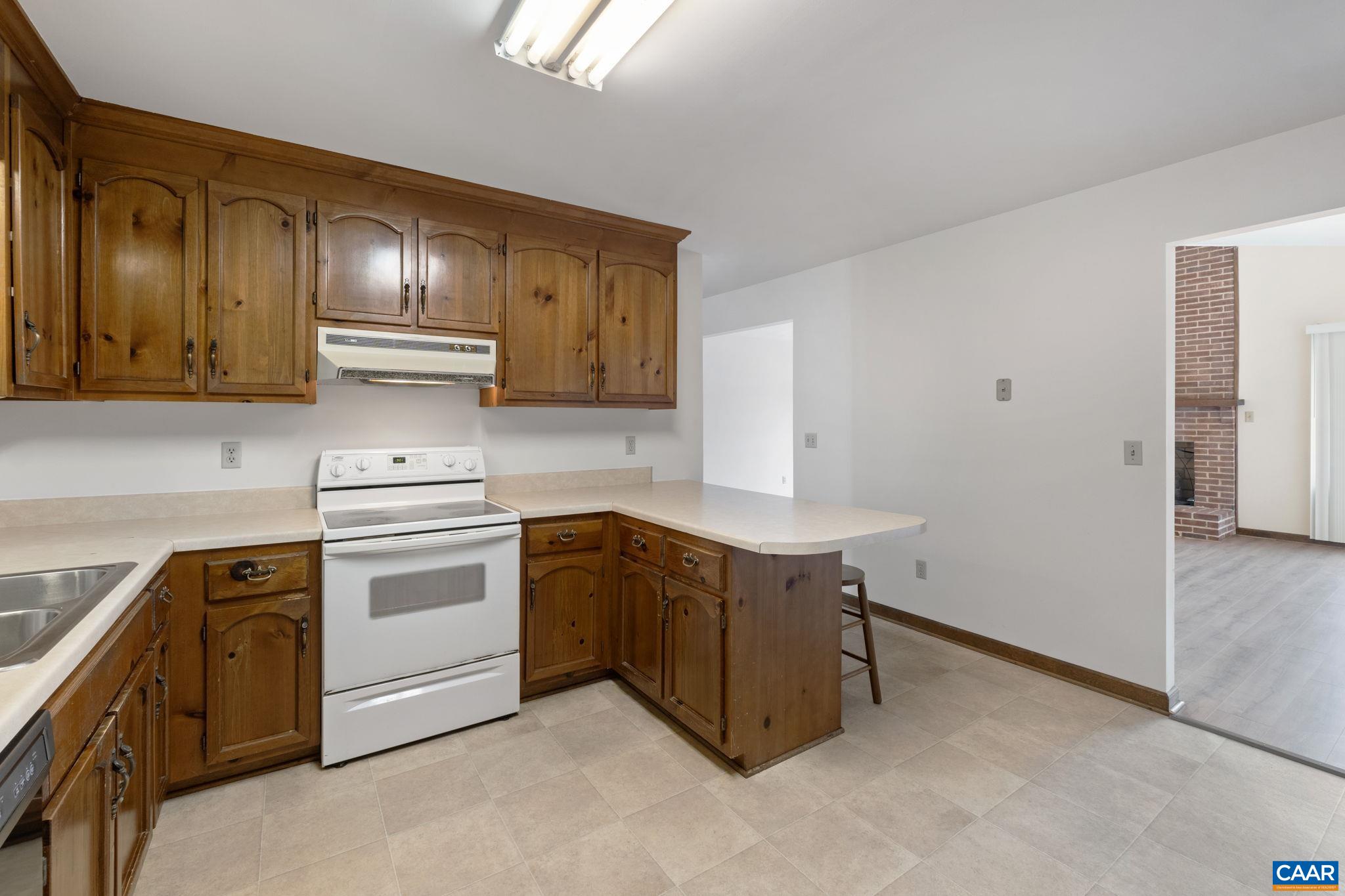 43 Tanglewood Road Palmyra, VA 22963 - Photo 22 of 64 a kitchen with stainless steel appliances granite countertop a stove and a refrigerator