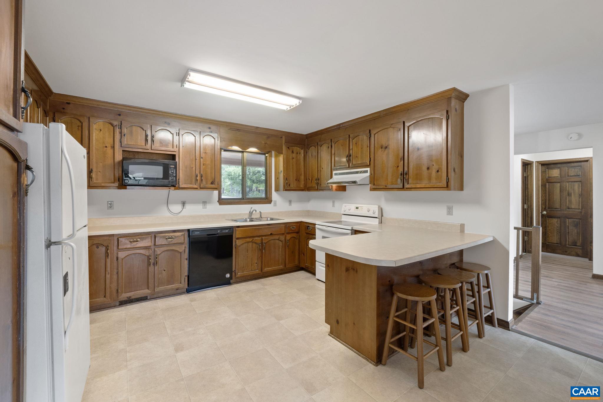 43 Tanglewood Road Palmyra, VA 22963 - Photo 24 of 64 a kitchen with a sink stove and refrigerator