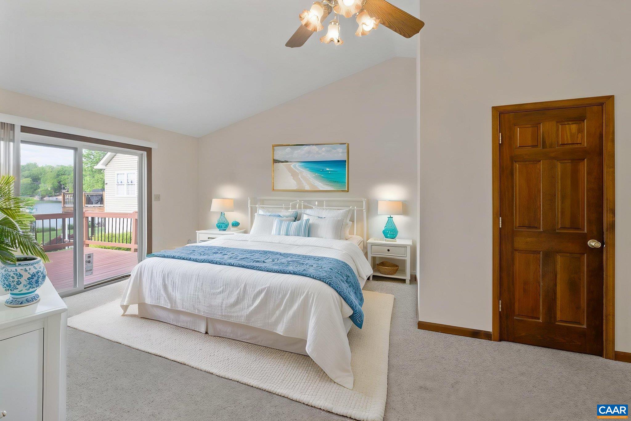 43 Tanglewood Road Palmyra, VA 22963 - Photo 27 of 64 a bedroom with a large bed and a chandelier