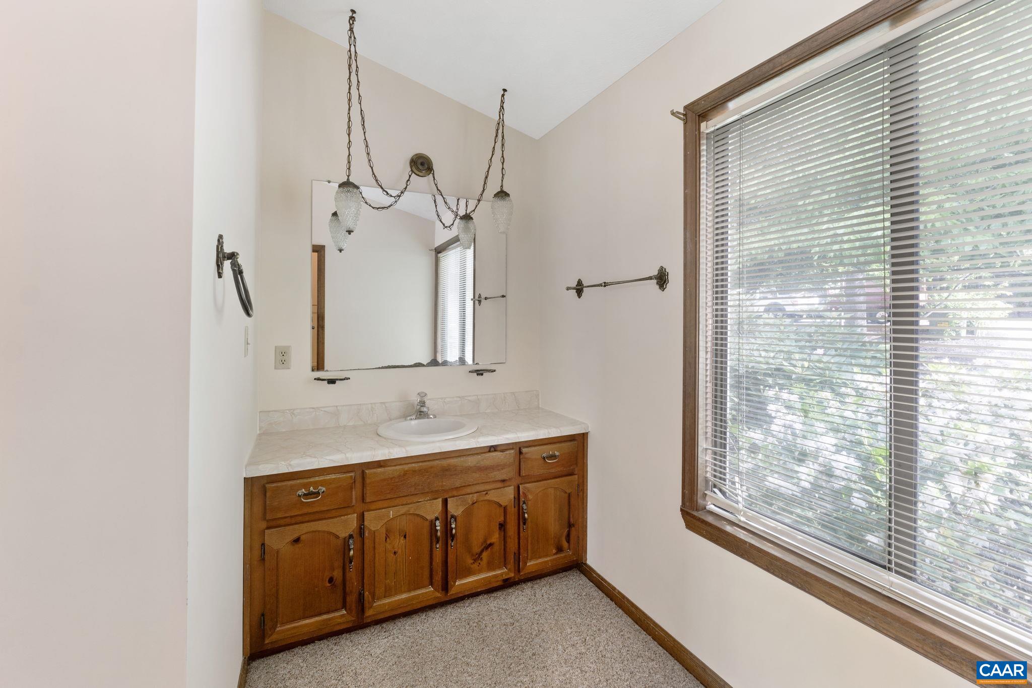 43 Tanglewood Road Palmyra, VA 22963 - Photo 29 of 64 a bathroom with a granite countertop sink a mirror and a shower