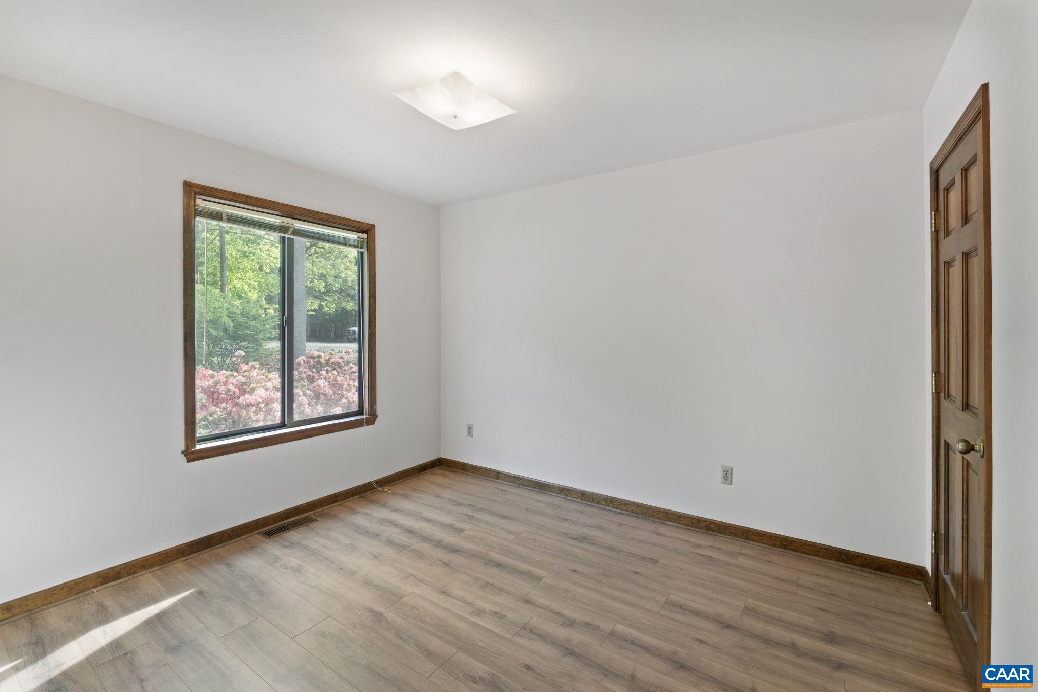 43 Tanglewood Road Palmyra, VA 22963 - Photo 33 of 64 a view of an empty room with wooden floor and a window