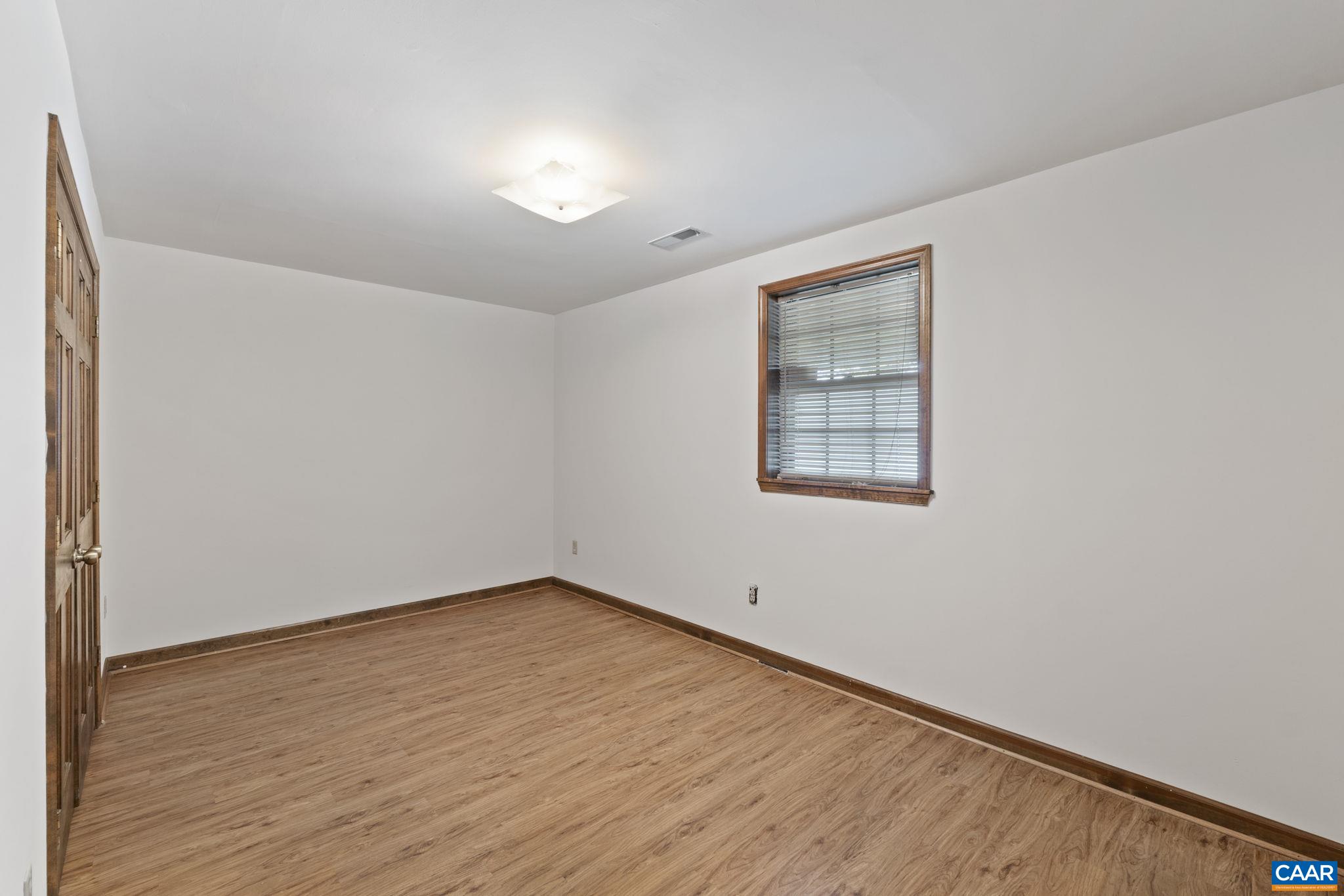43 Tanglewood Road Palmyra, VA 22963 - Photo 41 of 64 an empty room with wooden floor and windows