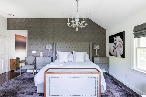 a bed room with a bed and a chandelier