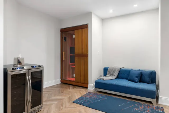 a living room with a couch and a stove top oven