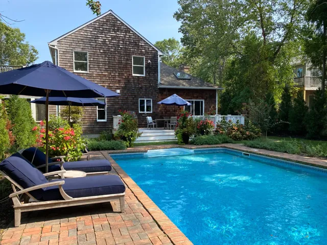 a front view of house with yard and outdoor seating