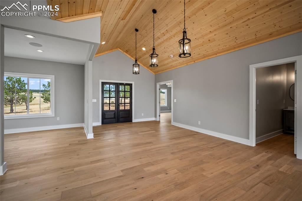 18775 Sweet Road Peyton, CO 80831 - Photo 15 of 50 a view of an empty room with window and wooden floor