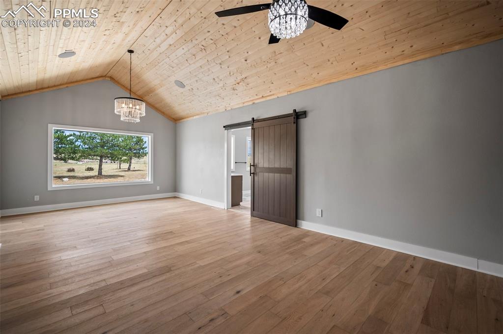 18775 Sweet Road Peyton, CO 80831 - Photo 16 of 50 an empty room with wooden floor and windows
