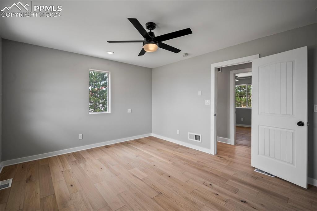 18775 Sweet Road Peyton, CO 80831 - Photo 25 of 50 a view of an empty room with wooden floor and a ceiling fan