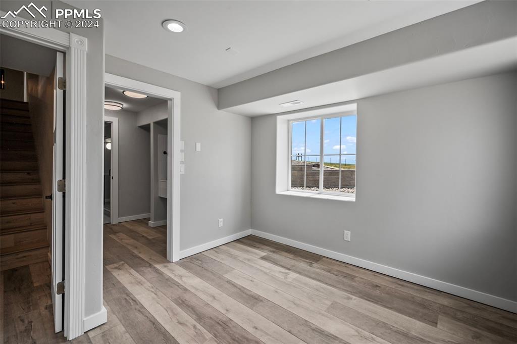 18775 Sweet Road Peyton, CO 80831 - Photo 27 of 50 a view of an empty room with wooden floor and a window