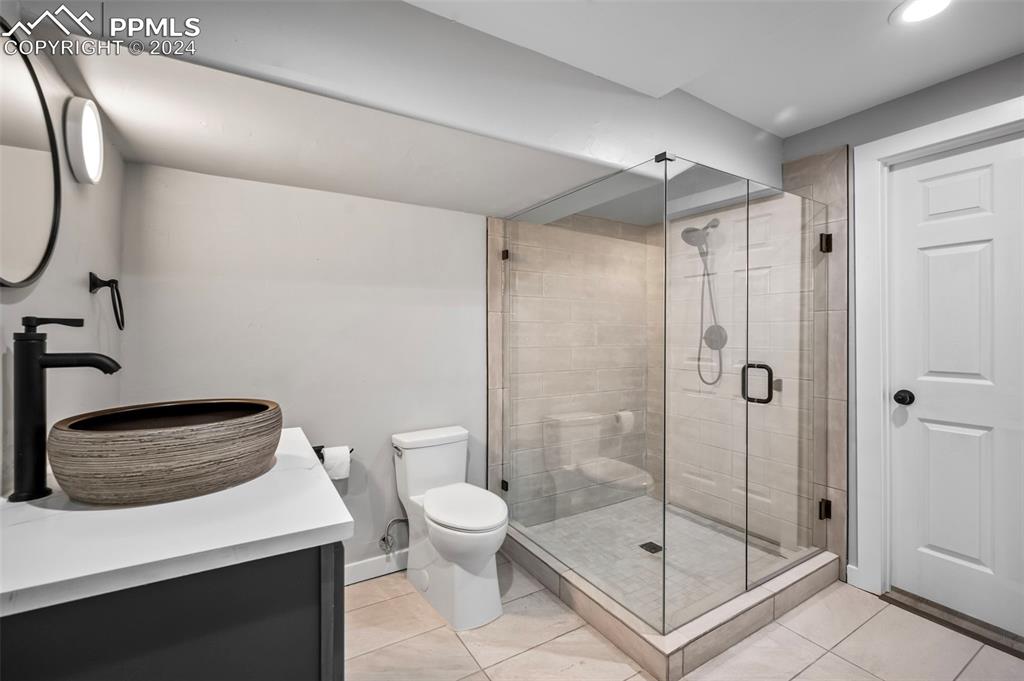 18775 Sweet Road Peyton, CO 80831 - Photo 31 of 50 a bathroom with a shower a toilet and sink