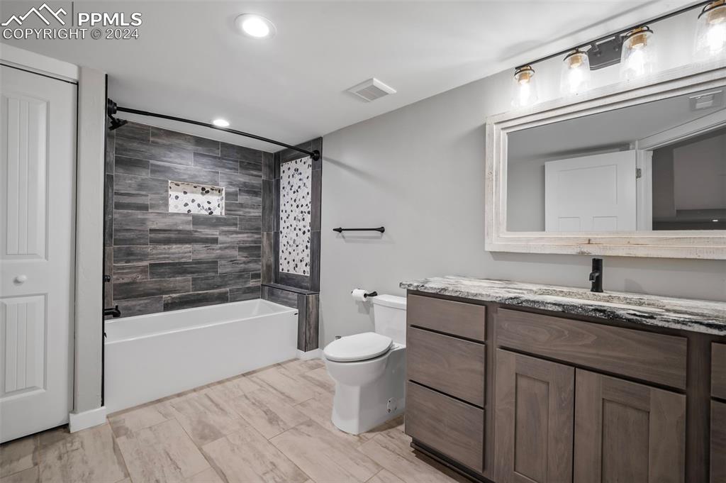 18775 Sweet Road Peyton, CO 80831 - Photo 37 of 50 a bathroom with a granite countertop sink toilet and shower