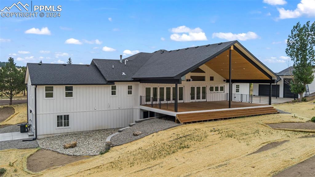 18775 Sweet Road Peyton, CO 80831 - Photo 4 of 50 a view of a house with a wooden deck and a backyard