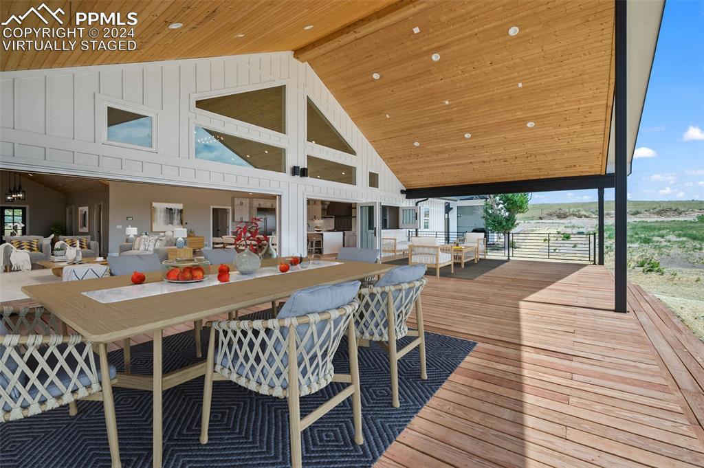 18775 Sweet Road Peyton, CO 80831 - Photo 42 of 50 a dining room with furniture and a floor to ceiling window
