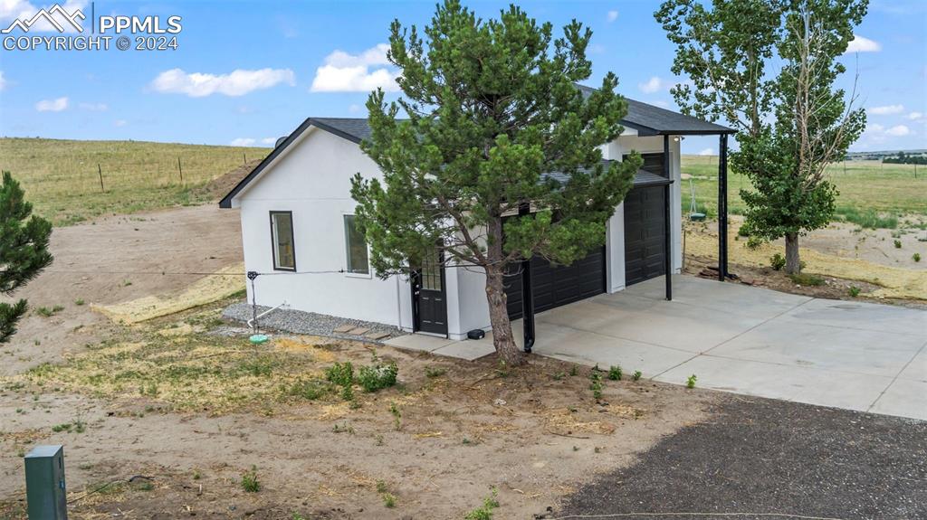 18775 Sweet Road Peyton, CO 80831 - Photo 44 of 50 a view of a house with a tree in the background