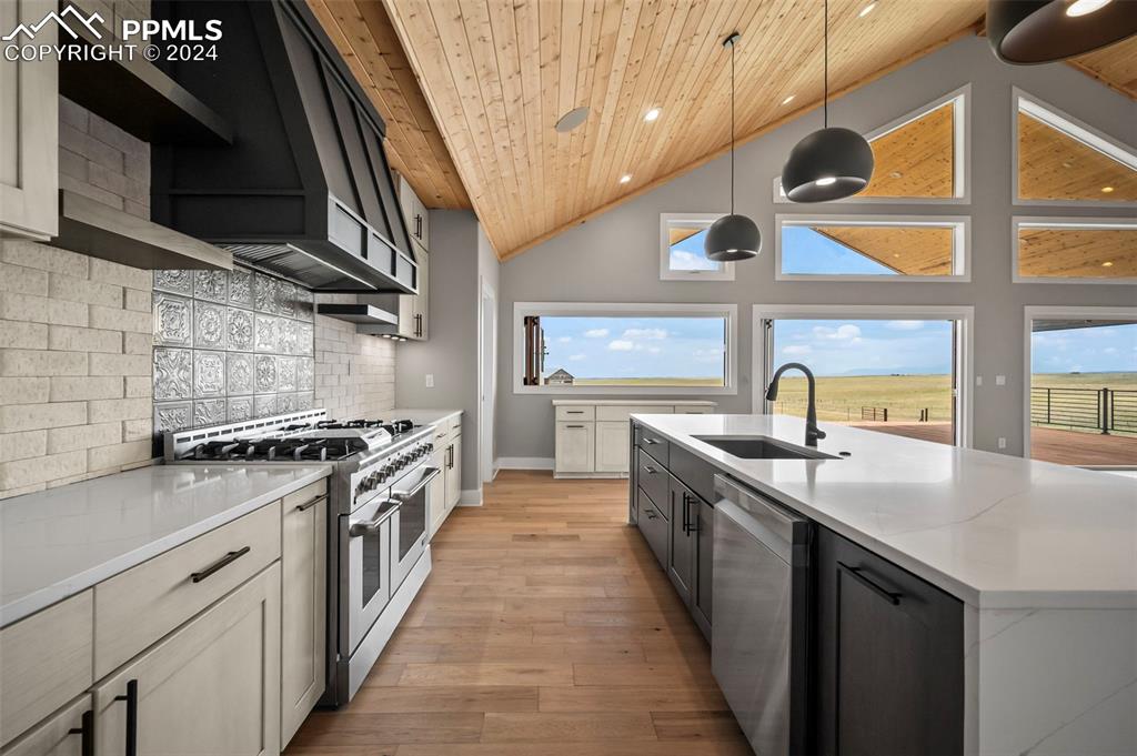 18775 Sweet Road Peyton, CO 80831 - Photo 10 of 50 a kitchen with stainless steel appliances granite countertop a sink and a stove