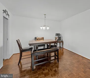 a view of a dining room with furniture and chandelier