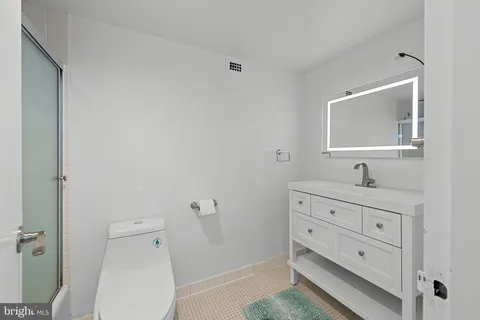 a bathroom with a toilet a sink and mirror