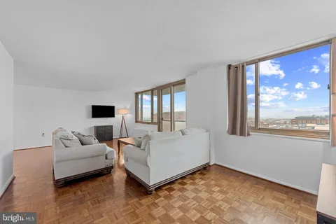a living room with furniture and a large window