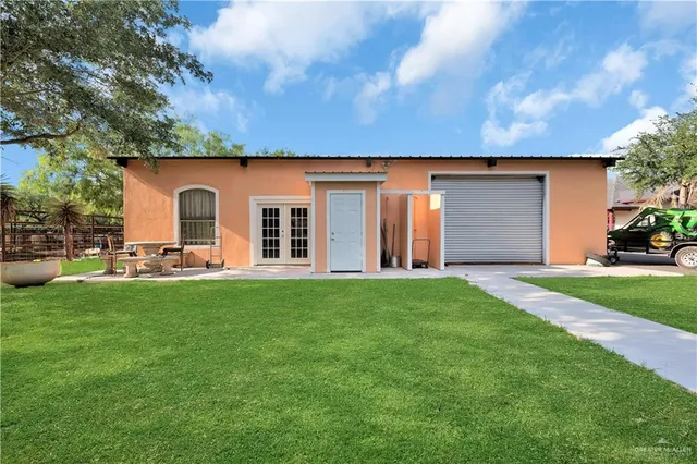 a backyard of a house with table and chairs