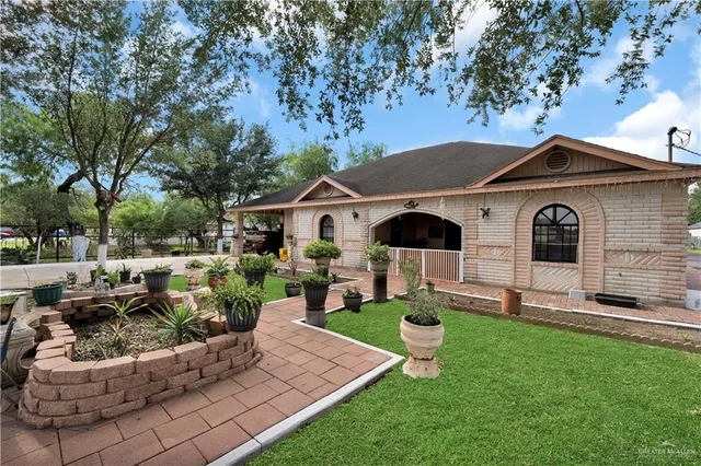 a front view of a house with a garden