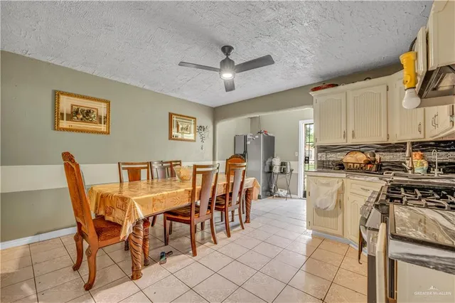 a view of a dining room with furniture and a kitchen