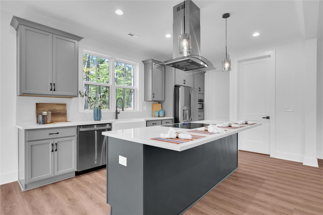 407 Blue Ridge Court Westminster, SC 29693 - Photo 10 of 48 This modern kitchen features a spacious island and sleek stainless steel appliances, perfect for culinary endeavors.