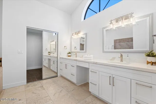a spacious bathroom with a granite countertop sink mirror and double