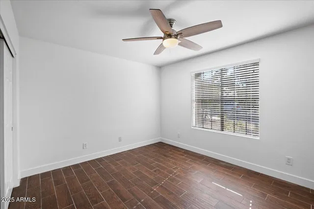 wooden floor in an empty room with a window