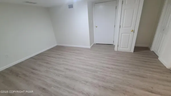 a view of a room with wooden floor