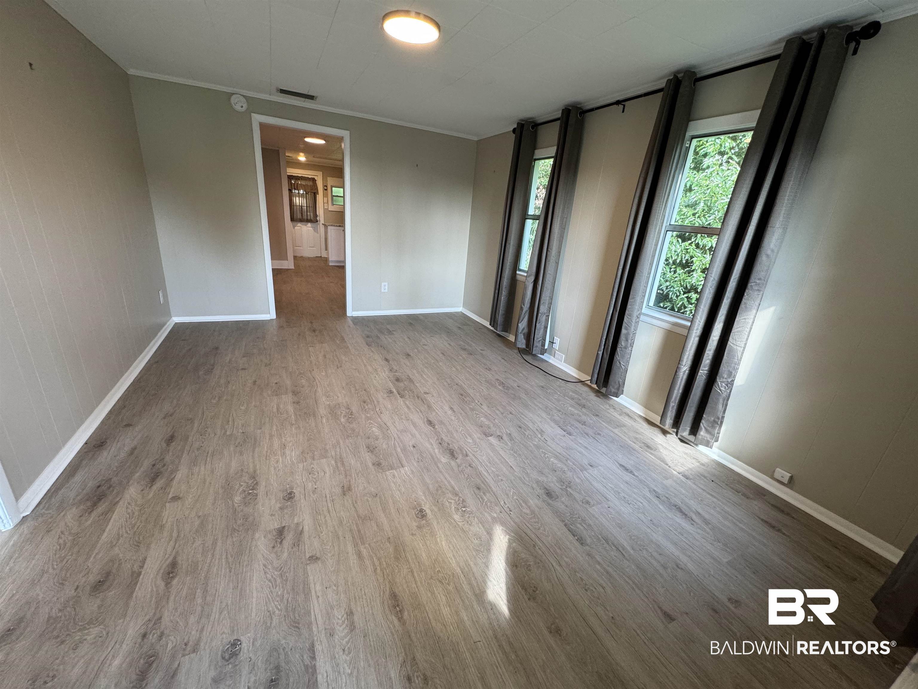 22640 Racine Street Robertsdale, AL 36567 - Photo 32 of 40 Spare room with wood finished floors and crown molding