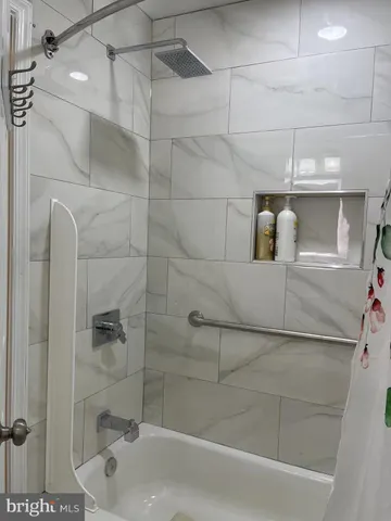 a bathroom with a bathtub and shower