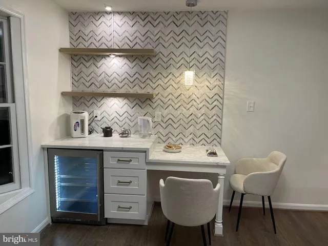 a living room with furniture and a lamp