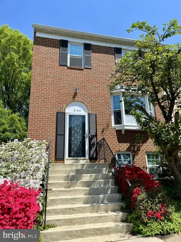 a front view of a house with a yard and outdoor seating