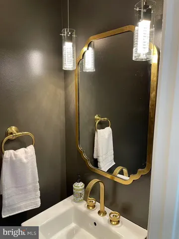 a bathroom with a sink and mirror