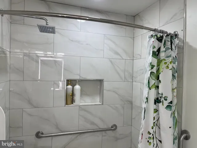 a bathroom with a shower and a mirror