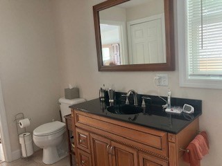 24 Indian Stone Road Phillipston, MA 01331 - Photo 18 of 21 a bathroom with a granite countertop sink a toilet and mirror