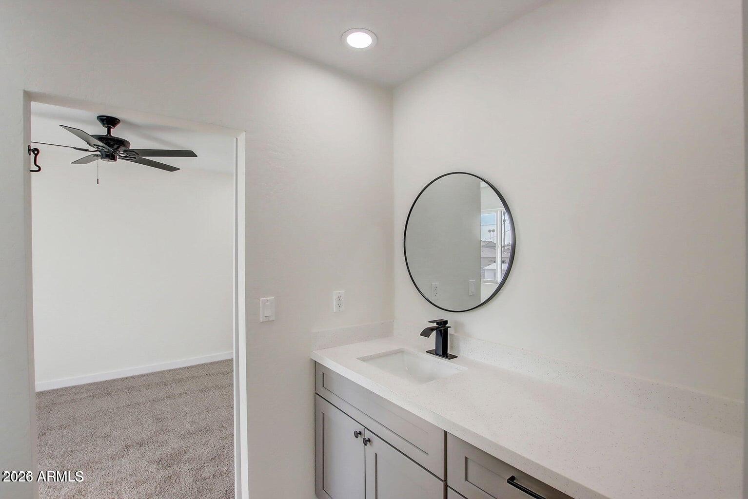 2509 East Broadway Road Phoenix, AZ 85040 - Photo 11 of 47 a bathroom with a sink and a mirror