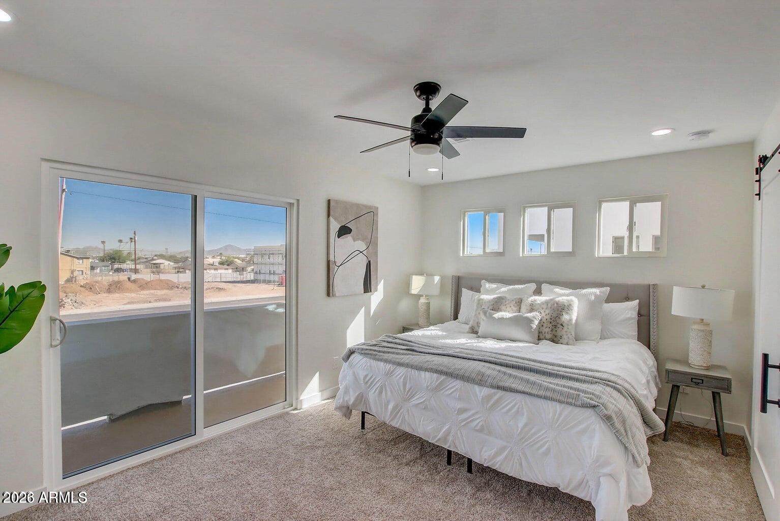 2509 East Broadway Road Phoenix, AZ 85040 - Photo 27 of 47 a bedroom with a large bed and a chandelier