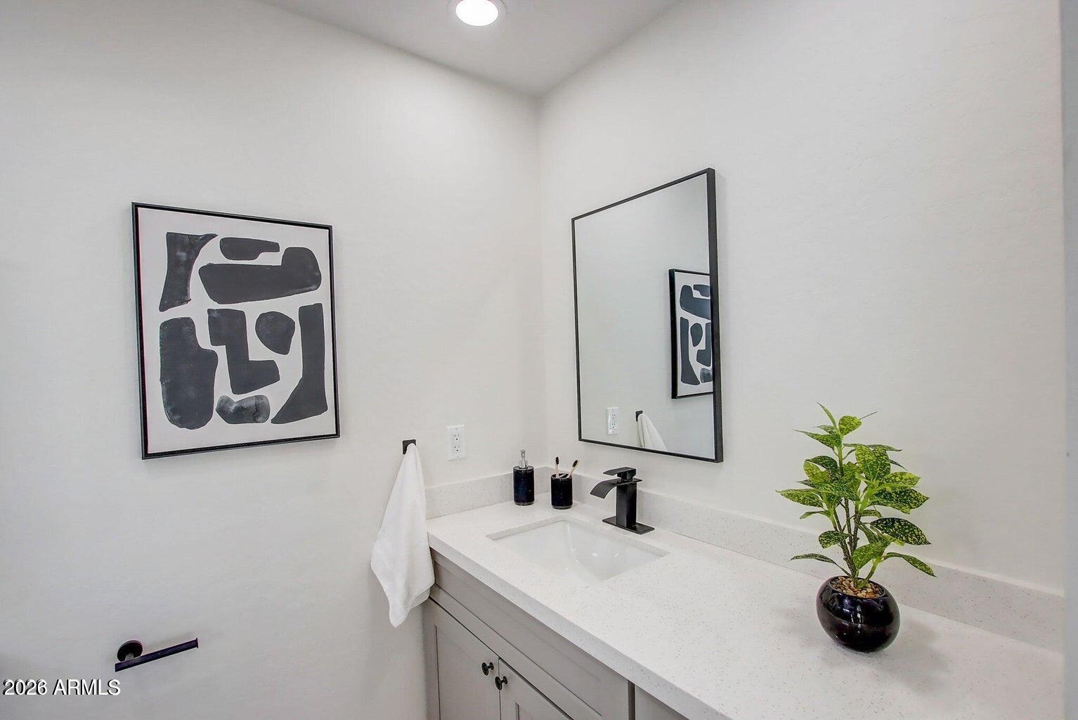 2509 East Broadway Road Phoenix, AZ 85040 - Photo 28 of 47 a bathroom with a sink and a mirror