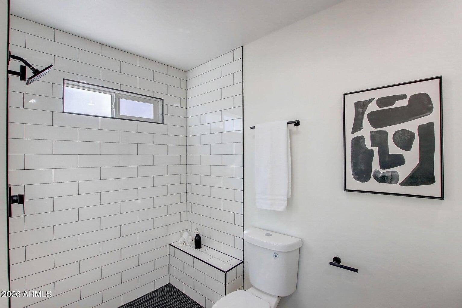 2509 East Broadway Road Phoenix, AZ 85040 - Photo 29 of 47 a bathroom with a toilet and a shower