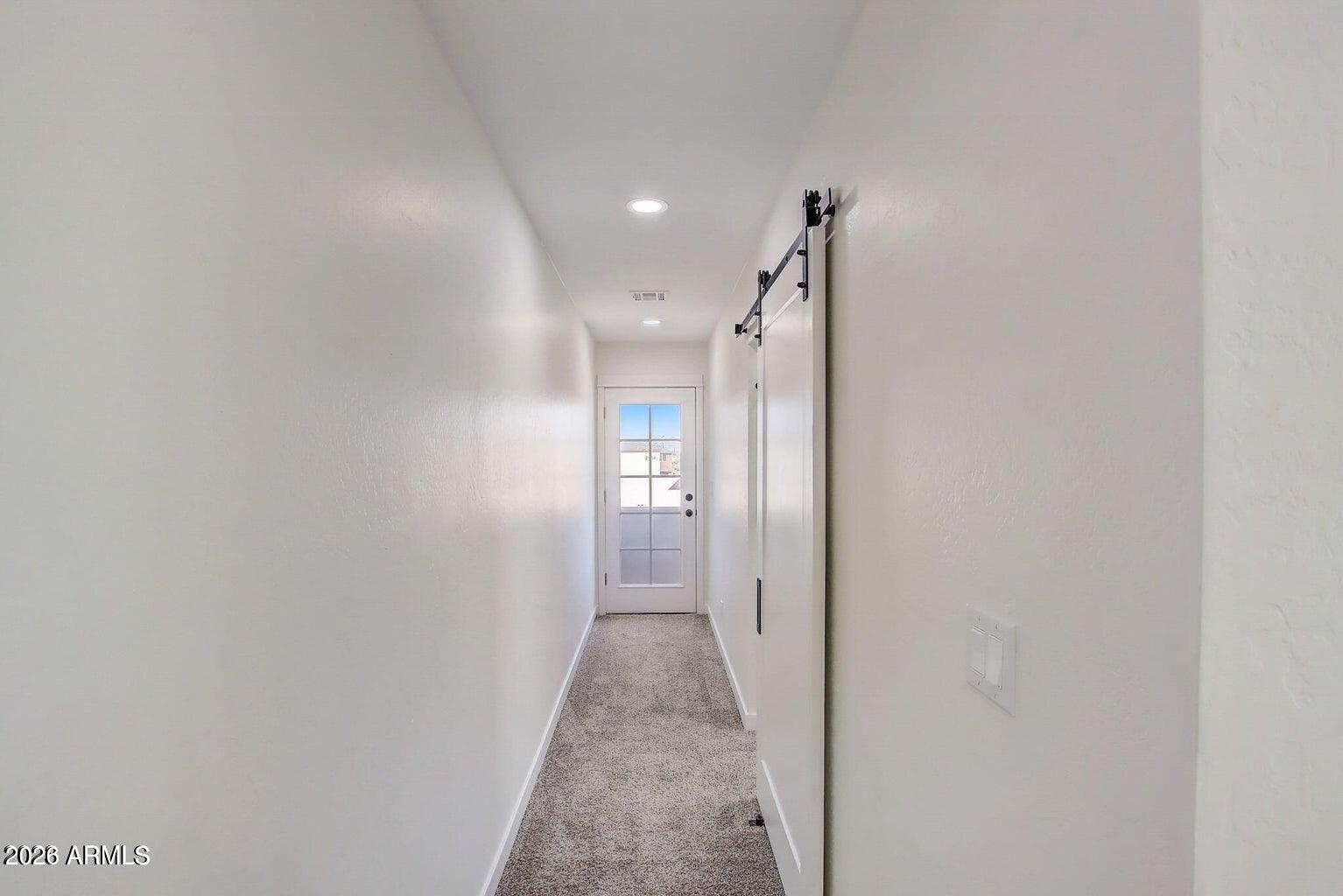 2509 East Broadway Road Phoenix, AZ 85040 - Photo 30 of 47 a view of a hallway with wooden floor and a bathroom