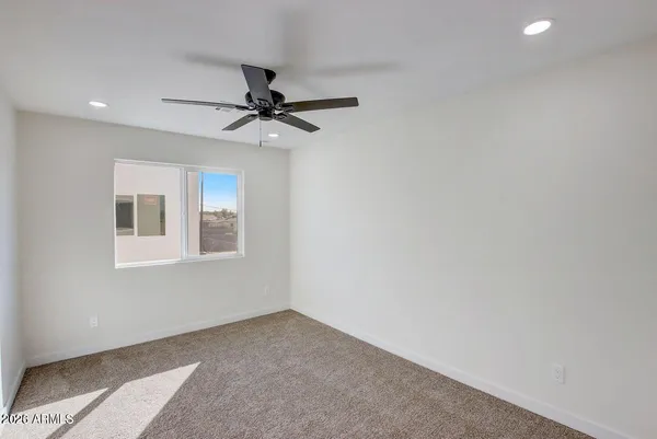 an empty room with projector and windows