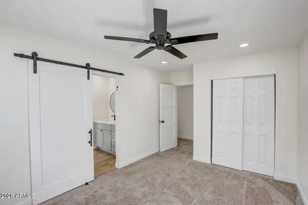 a view of a room with a ceiling fan