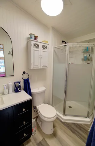 a bathroom with a toilet a sink and shower