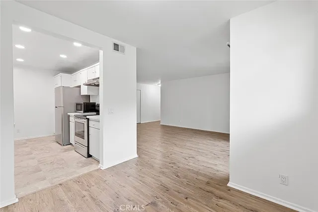 a view of kitchen and wooden floor