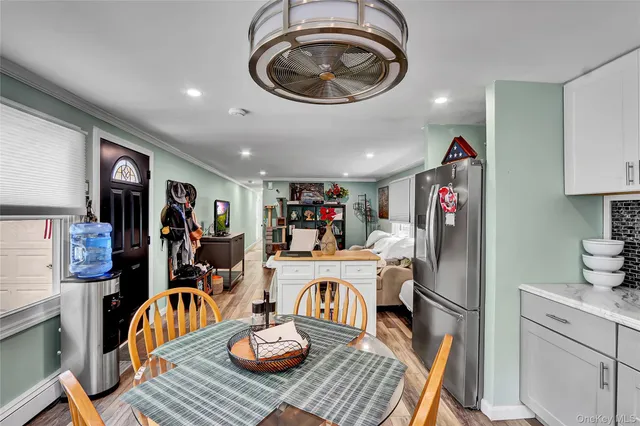 a kitchen with a refrigerator and a stove top oven